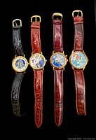 Front view of all four watches showing dials and straps