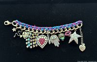 Front view showing braided chain and 14 assorted charms