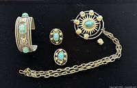 Set showing bracelet, earrings, pendant on chain and loose accent