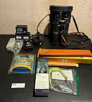 Overall lot including binoculars, CB radio, Fitbit set, charger, slide rules