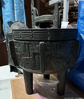 Tripod lidded ice bucket showing detailed etched exterior patterns