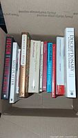 Box containing 10 various books seen from above, showing titles and spines clearly.
