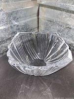 Heavy clear crystal bowl with fluted, scalloped edges and vertical cut rib pattern
