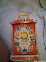 Front panel showing teaching clock illustrations and Fisher-Price branding