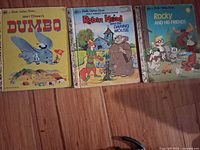Front covers of three vintage Little Golden Books: Dumbo, Robin Hood and the Daring Mouse, Rocky and His Friends.