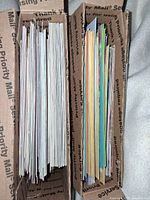 Top view showing two boxes filled with numerous cards and envelopes neatly stacked.