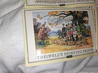 Book cover titled 'THELWELL'S SPORTING PRINTS' showing a scene of a man photographing a group of hunters with rifles and dogs in an autumn outdoor setting.