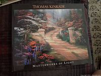 Cover of one hardcover Thomas Kinkade art book titled 'Masterworks of Light' showing a bright garden pathway scene.