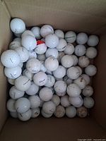 Box containing 83 Titleist golf balls from various angles showing condition and quantity.