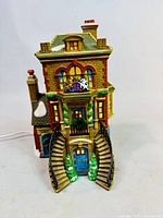 Front view showing full façade, staircases, wreaths, power cord