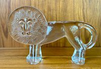 Front side view of the crystal glass lion figurine showing engraved mane and body shape.