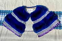 Full top view of the royal blue chinchilla fur shawl with silk lining and white embroidered trim on purple border.