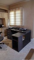 Full view of L-shaped desk showing drawer pedestal and open storage