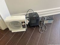 All three items grouped: white Seabreeze heater, black Lancaster heater, gray Airitech battery