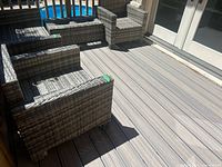 Full view of both vinyl wicker-look patio chairs on deck