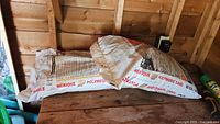 Two polymeric sand bags on shed shelf