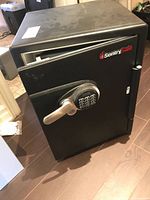 Full view of black SentrySafe safe with door ajar