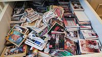 Drawer filled with large pile of assorted sports trading cards