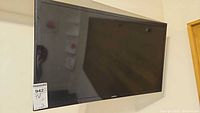Front angled view of Samsung TV mounted on wall