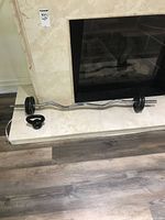 Full view of EZ curl bar with plates and kettlebell