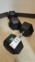 Pair of large rubber hex dumbbells on floor