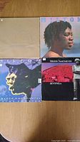 Four Milton Nascimento vinyl records with front album covers visible including Geraes, Milton, Em a Barca dos Amantes, Sentinela