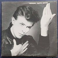 Front cover of the 'Heroes' album showing a black and white photo of David Bowie in a distinctive pose.