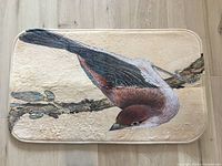 Full view of printed door mat front showing bird design
