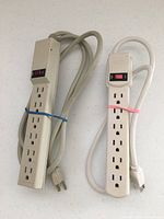 Front view of both power strips showing outlets and switches