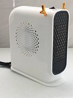 Side view of white space heater showing grille and design