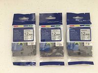 Front view of three packaged 12 mm label tape cassettes