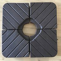 Top view of four plates assembled in square showing central pole opening and textured surface