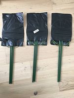 Three packaged plant support stands