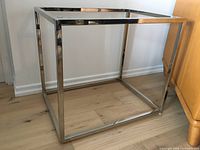 Overall view of rectangular steel frame side table without top