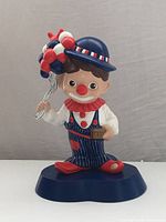 Front view of ceramic balloon vendor clown figure