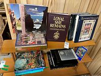 Shelf of assorted art and history books including Loyal She Remains, History of Art, Leonardo volumes, Spain book