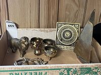 Box containing assorted brass items