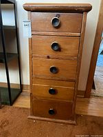 front view of chest showing five drawers and knobs