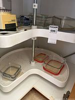 Processor and several glass containers on cabinet shelf