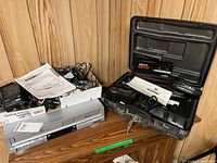 Citizen DVD/VCR combo, Minolta camcorder in open case with accessories and manuals