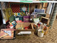 Overall lot showing board games, puzzles, model kit, die-cast truck and game pieces