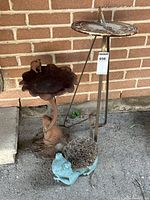 Full view of sundial, bird bath, boot scraper