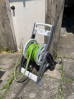 Front view of hose reel cart showing hose and handle