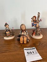 All three Goebel Hummel figurines on tabletop
