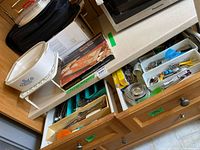 Overall lot showing CorningWare casserole, Pyrex pack box, utensils in drawers