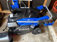 Top and side view of Kobalt 80V Max brushless snow thrower showing main body, handle, discharge chute detached, battery compartment