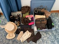 Overview of lot showing handbags, gloves, wigs, hat, perfume, organizer, eyeglass case