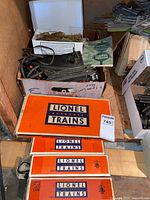 Four orange Lionel Electric Trains boxes stacked, top marked 6019