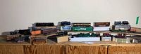 Wide shot of all HO scale locomotives and cars on cabinet