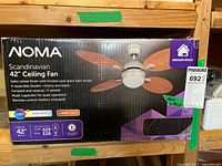 Front of sealed retail box showing NOMA Scandinavian 42" Ceiling Fan imagery and specifications